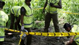 Police officers work at the explosion site in Pugoda on the east outskirts of Sri Lankan capital Colombo
